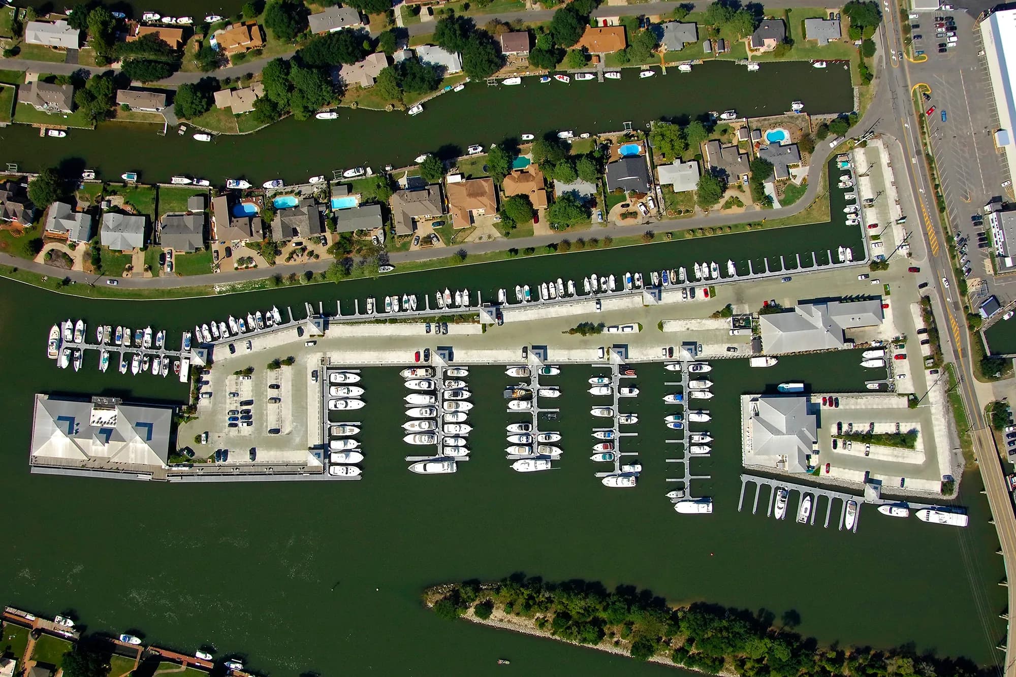 Yachts moored along a busy East Coast marina at dusk